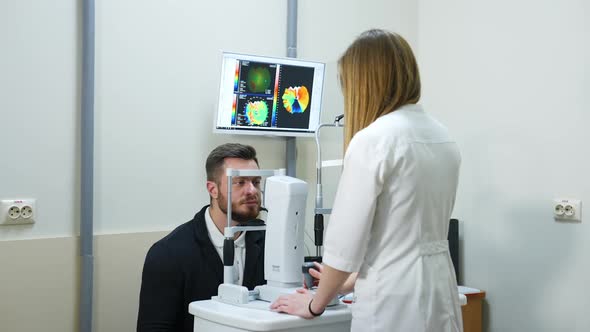 Eye exam for man. Portrait of man during test on refractometer machine