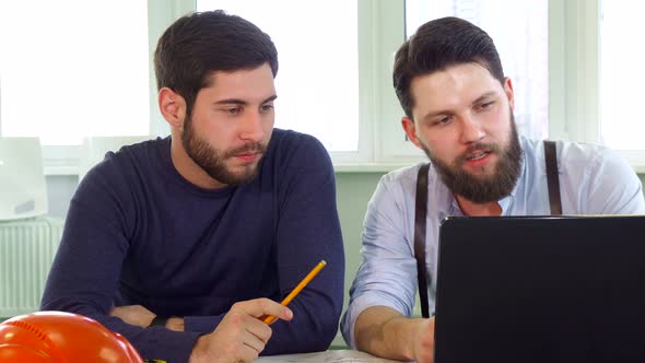 Two Architects Looking at Laptop Screen