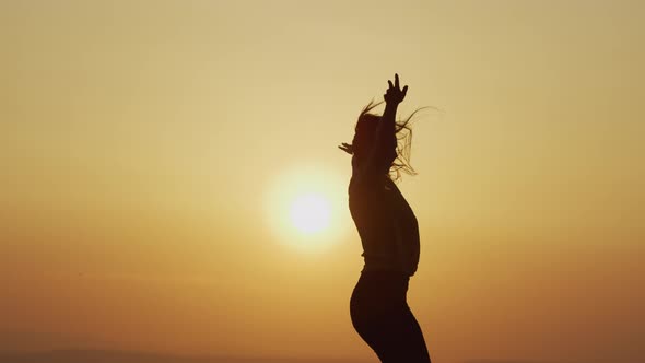 Woman dancing at sunset