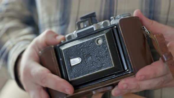 Close-up vintage photo camera details, setting up the film camera.