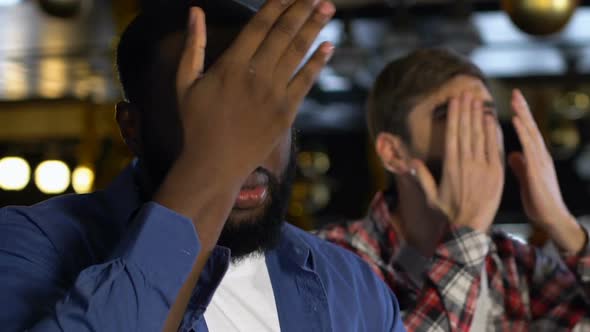 Multiethnic Men Disappointed About Favorite Team Losing Game, Facepalm Gesture