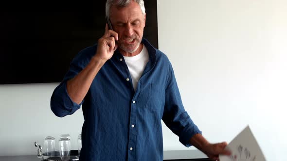 Frustrated male executive talking on mobile phone