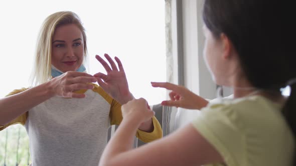 Mother and daughter talking to each other through sign language