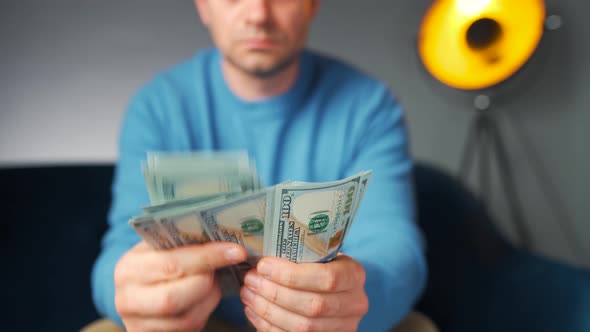 Man Counting US Dollar Bills or Paying in Cash