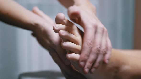 Masseur Hands Massage the Legs of a Child in a Massage Room