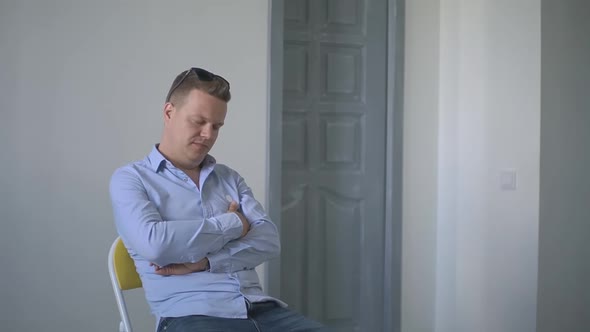 a Person in the Office Falls Asleep on a Chair