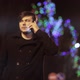 A man in a black coat talking on a smartphone while walking in the city at night - VideoHive Item for Sale