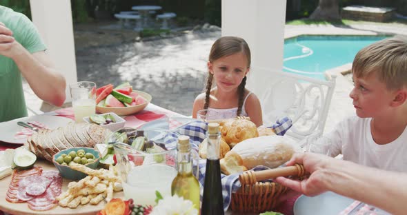 Happy family eating together at table