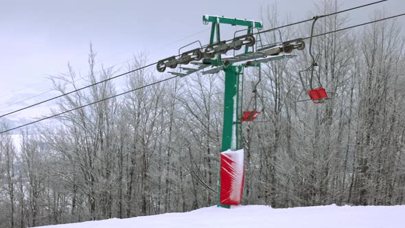 View of the Ski Lift Against the Background of a Mountain Forest and Gray Sky in the Carpathians