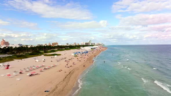 Tourists in Miami Beach on winter vacation. 4k aerial drone video 60fps