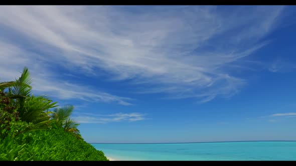 Aerial drone shot travel of tranquil island beach lifestyle by shallow lagoon and white sandy backgr