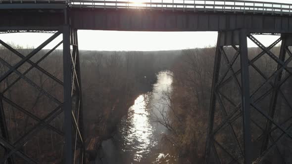 Slowly rising above the Appomattox River reflecting afternoon sunlight to reveal High Bridge Trail,