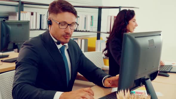 Business People Wearing Headset Working in Office