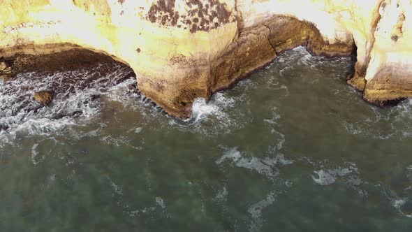 Aerial view of Atlantic Ocean and rock cliff, Carvoeiro. aerial forward 