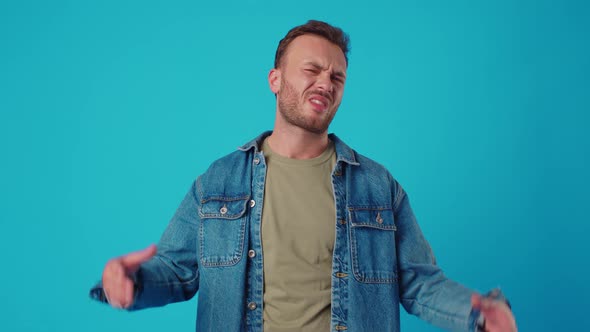 Young Man Showing Blabla Gesture Against Blue Studio Background