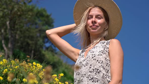 Blonde with Straw Hat Posing in the Field