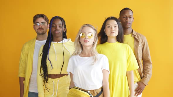 Studio Shoot of Encouraged Models of Diverse Races Isolated on Yellow Background, Friendship Concept