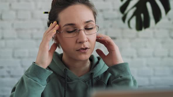 White Woman Struggling with Using Laptop at Home