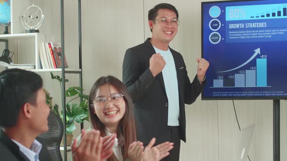 Asian Businessman Presentation To His Business Colleagues, They're Happy And Celebrate, Charts On TV