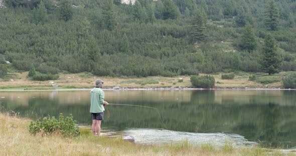 Fly Fishing On Mountain Lake In Pirin In Bulgaria