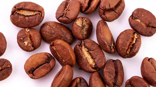 Roasted Ripe Brown Coffee Beans in a Heap Lie on a White Background