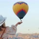 Woman Supports with Her Hand From Below a Balloon Flying in the Sky - VideoHive Item for Sale