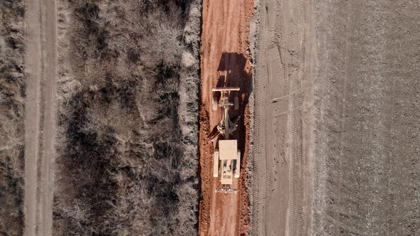 Aerial Drone Shot of Road Grader Smoothing Gravel Surface for New Road