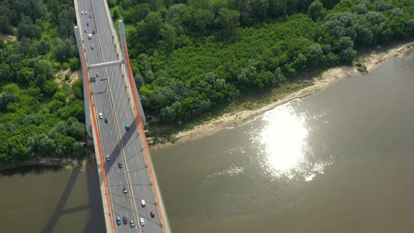 Aerial or top view from drone of concrete bridge with asphalt road or highway over big river with ci