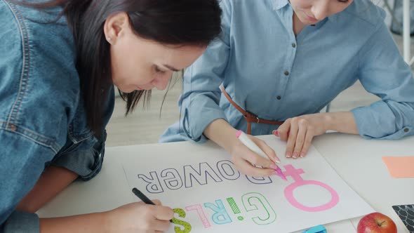 Slow Motion of Asian and Caucasian Women Drawing Girl Power Banner and Talking