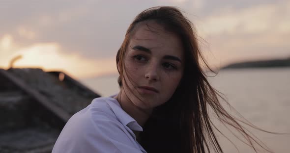 Young Cute Woman Relaxing Sitting on the Pier