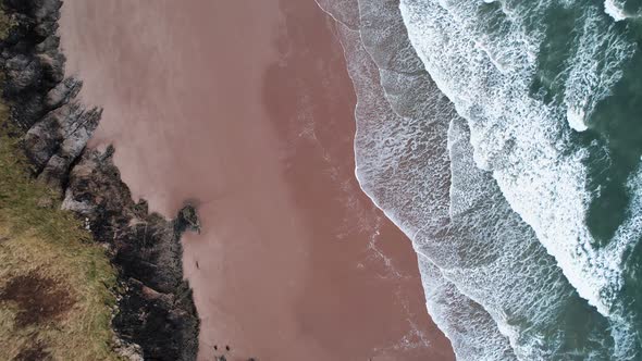 AERIAL: Top down dolly along orange sand beach, Blue Pool Bay, 4k Drone