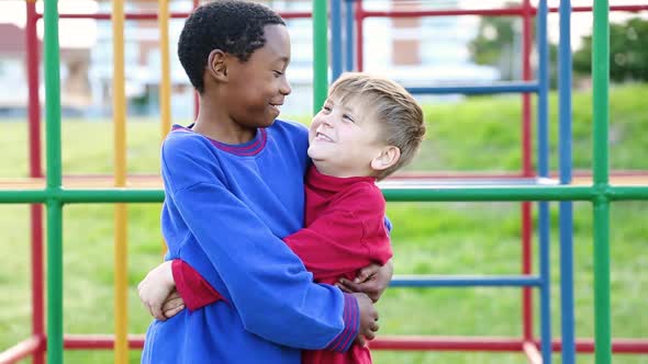 Portrait of two young best friends smiling and giving each other hugs