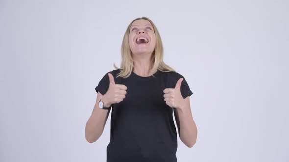 Young Happy Blonde Woman Looking Excited While Giving Thumbs Up