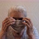 Slow Motion Portrait of an Old Woman Putting on a Protective Medical Mask. - VideoHive Item for Sale