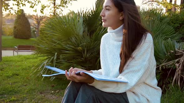 Slow Motion Studying Happy Young Woman Reading Her Book for School. Beautiful Mixed Race Asian