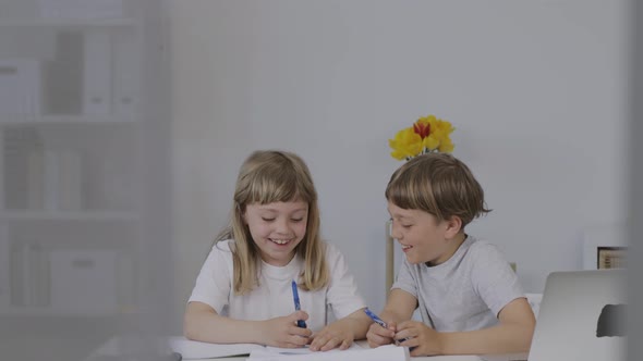 Brother Helps His Younger Sister to Make Her Homework