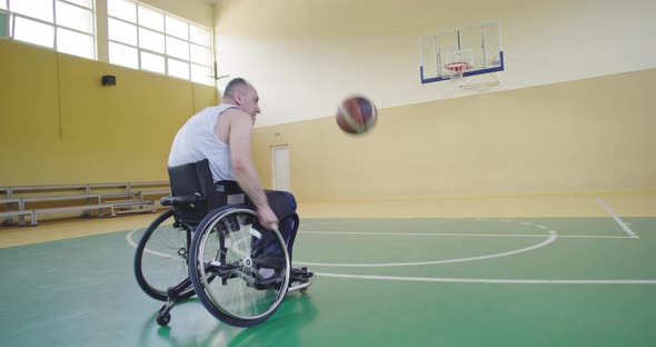 A Person with Disabilities Playing Basketball in the Modern Hall