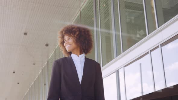 Smiling Businesswoman Walking Outside Office