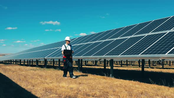 Maintenance Man with a Laptop Is Observing a Solar Power Field. Solar Power, Solar Panel, Solar Farm