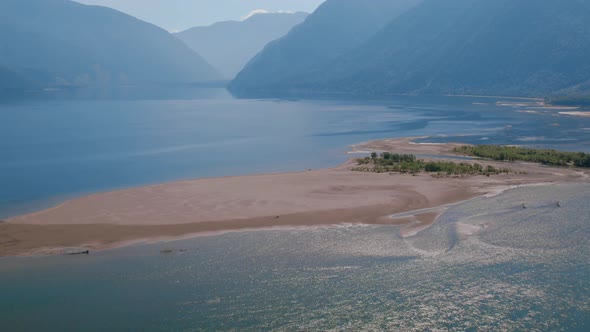 Lake Teletskoye between mountains with blue clear sky in Altai