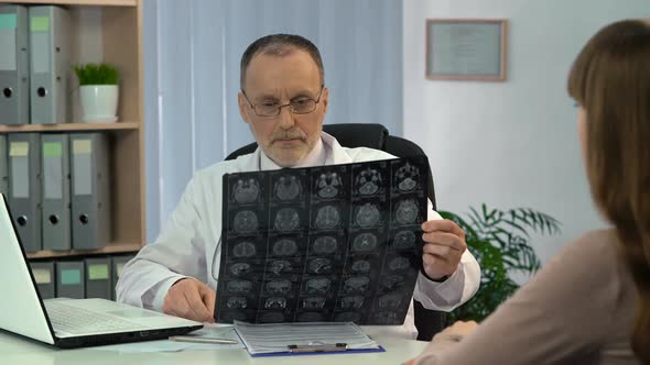 Doctor Informing Female Patient About Good Results of Brain MRI, Recovery