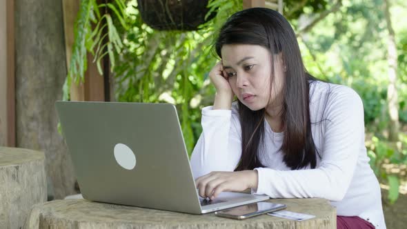 Bored Young Woman Working With A Laptop