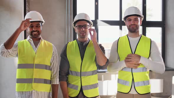 Happy Smiling Male Architects in Helmets at Office