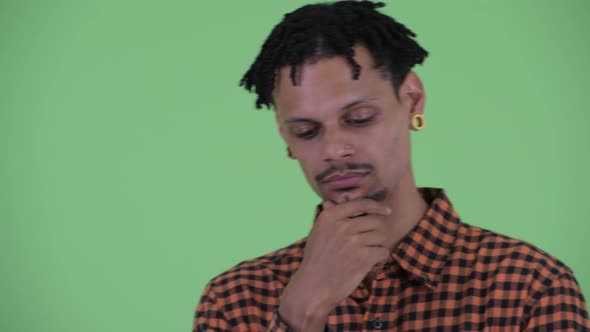 Face of Stressed Young African Man Thinking and Looking Down