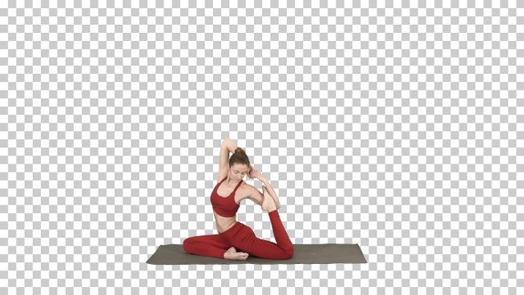 Beautiful young woman wearing red sportswear doing yoga