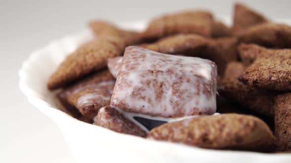 Soak nutritious chocolate cereal pads with milk on a textured porous surface