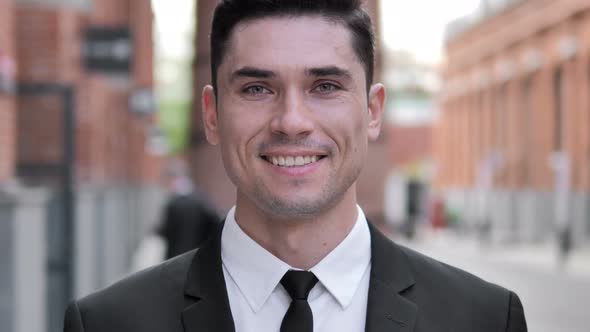 Outdoor Portrait of Young Smiling Businessman