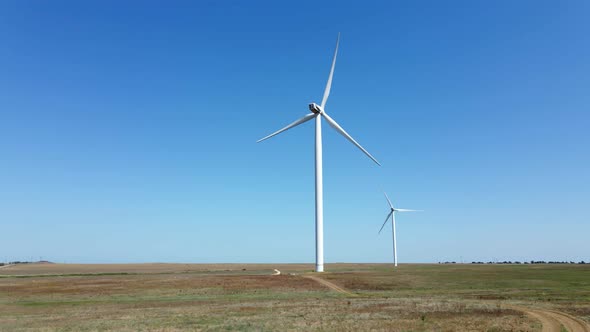 Working Wind Turbines Standing on the Field in Summer