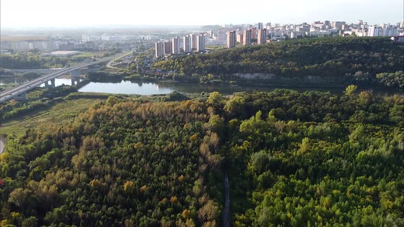 View of the Forest Road Road Bridge Over the River and Urban Residential Highrise Buildings Shooting