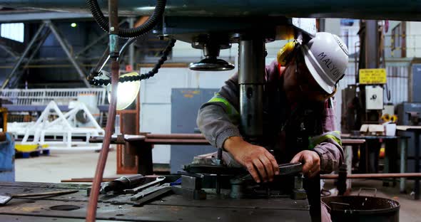 Male Engineer Working on A Machine  alt